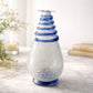 Vaso monofiore Le Favole in vetro craquelé trasparente con girali blu H29x16 cm